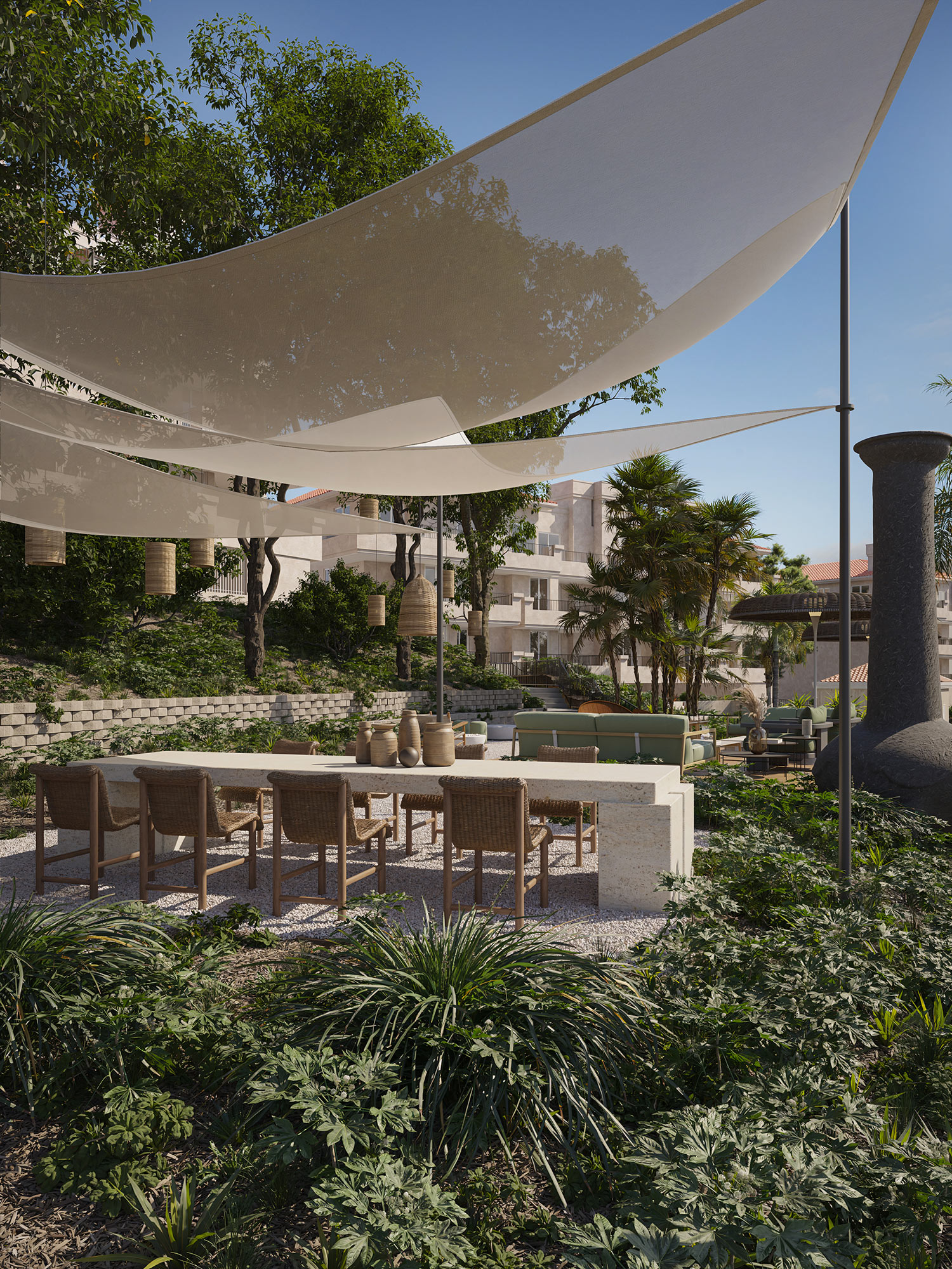 Outdoor alfresco dining area featuring a concrete outdoor kitchen island with natural wood bar stools, sculptural fabric shade canopies, and lush tropical landscaping.